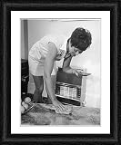 Framed Print of LADY POLISHES A TABLE from Mary Evans