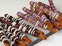 Milk Chocolate Covered Pretzel Rods in a Lucite Cylinder