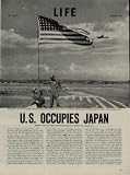 U.S. OCCUPIES JAPAN - Soldiers of the 11th Airborne Division watch the American Flag flap in the breeze, above their control point on Atsugi Airfield near Tokyo. ..... 1945 LIFE Magazine Article, A4803A.