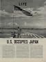 U.S. OCCUPIES JAPAN - Soldiers of the 11th Airborne Division watch the American Flag flap in the breeze, above their control point on Atsugi Airfield near Tokyo. ..... 1945 LIFE Magazine Article, A4803A.