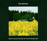 BRIGHT YELLOW FLOW CDERS ON A DARK DOUBLE BED
