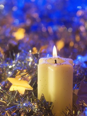 Lighted candle arrangement surrounded by Christmas decorations Photographic Poster Print, 12x16