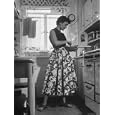 Career Girl Hostedd Joan Wilson in skirt and sleeveless blouse cooking in kitchen Photographic Poster Print by Nina Leen, 30x40