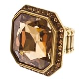 Gold tone stretch band ring with amber crystal surrounded by golden rhinestones.