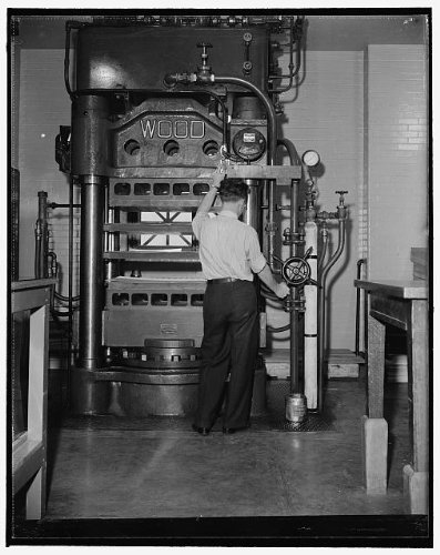 Photo Reprint National Archives. Washington, D.C., Nov. 22. In the powerful press, the sheets of acetate, under heat
