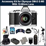 Olympus OM-D EM-5 Micro Four Thirds Digital Camera Accessory Kit. Package Includes: Olympus EM-5 Digital Camera with 12-50mm Lens(Silver), 2 Extended Life Replacement Battery Packs, Rapid Travel Charger, 32GB Memory Card, Memory Card Reader, Memory Card Wallet, Lens Hood, Lens Cap Keeper, Flash, Monopod, 50 Tripod, Table Top Tripod, LCD Screen Protectors, Cleaning Kit & Large Carrying Case