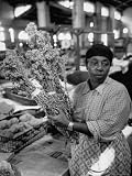 Woman Carrying Rabbit Tobacco in the Old City Market Building Photographic Poster Print by Robert W. Kelley, 12x16