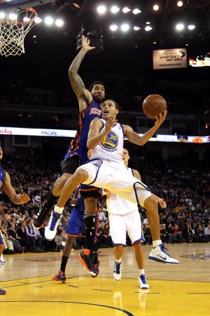 New York Knicks v Golden State Warriors: Stephen Curry and Wilson Chandler Photographic Poster Print by Ezra Shaw, 28x42