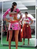 Woman in Miniskirt Holding Up Latest Style Midi Skirt While Looking in Store Mirror Photographic Poster Print by John Dominis, 12x16