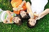 IMAGE OF Wallmonkeys Peel and Stick Wall Decals - Three Children Laying on Grass on Ground, Eating - 72