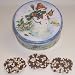 Scott's Cakes 1 lb. Milk Chocolate Covered Pretzel with Chocolate Chips & White Chocolate Chips in a Classic Snowman Tin