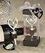  Put a modern twist on the classic heart design with Vineyard Collection heart themed wine stoppers There is perhaps no symbol that represents the essence of love better than the heart. And this uniquely stylized heart design wine stopper gives this timeless symbol truly updated flair! Each 4 ½ x 1 ¾ stopper features a freestyle chrome heart at its top with a solid chrome tapered bottom. From the exclusive Vineyard Collection , each chrome wine stopper is packaged upright in a deluxe clear box with a black top and bottom allowing a dramatic 360 degree view of the favor, finished with a white organza bow and a designer heart shaped thank you tag attached.
