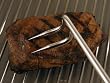 Grill Hook, a new twist for turning food.