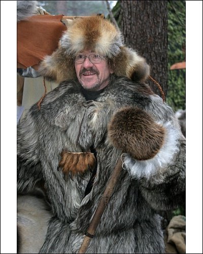 Photographic Print of Market stall holder in a wolf skin coat with a bear paw on his chest from ArcticPhoto