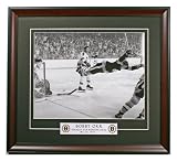 Boston Bruins Bobby Orr Scores the Stanley Cup Winning Goal. Framed 11x14 Photo with Boston Bruins logo.