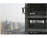 10x8 Photograph (25x20cm) A construction worker hangs off the side of the CYTS by Arcaid