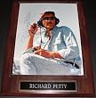 Richard Petty Autographed Racing 8x10 Photo on a wall plaque