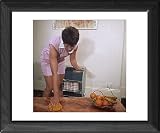 Framed Print of DUSTING A COFFEE TABLE from Mary Evans