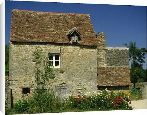 Canvas Prints of Close-up of exterior of a stone house, with cracked walls, and a flower bed, from Robert Harding
