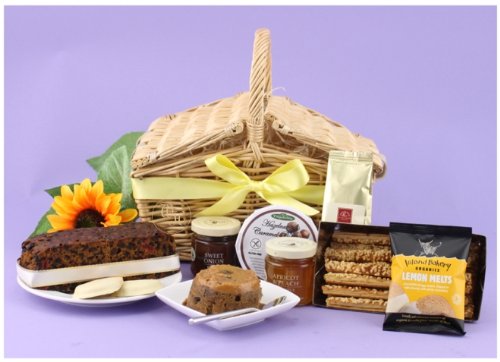 HAMPER TREAT - Twin flap traditional handwoven willow hamper packed with treats including fruit cake, Scottish oat pudding with delicious topping, lemon melt biscuits, sweet onion relish, apricot and peach preserve, cheese straws and after dinner coffee. Food hampers from Web Hampers.
