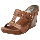 The rough-hewn straps of Nine West's Abam sandal get an urban edge with a curvaceous molded wedge. Gleaming mini studs and a decorative buckle add an eye-catching touch.