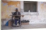 Box Canvas Print of A man works his sewing machine on Ibo Island from AWL Discover Images.com