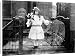 Canvas Prints of SPIRIT PHOTOGRAPH, c1905. A young girl holding flowers, surrounded by spectral from Granger Art on Demand