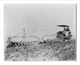 Historic Print (S): [Tractor pulling large set of discs across field]