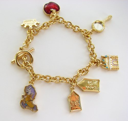 Click here to buy Disney Couture Gold Plated Story Book Multi Charm Bracelet With Dwarf, castle, Drink Me Eat Me... by Disney Couture.