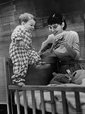 Babysitter Judy Fuss Reading to Little Boy at His Crib Photographic Poster Print by Leonard Mccombe, 12x16