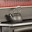 The Condar Half Kettle Steamer - MATTE BLACK with CHROME HANDLE (HK-BC) - is a humidifier especially designed for narrow ledges of fireplace inserts and woodstoves. Only 4-inches wide, yet it looks like a whole kettle when in place, and holds over 2 quarts of water! A similar capacity to most full-size kettles. This unique, patented design features a spout cleverly sculpted to direct steam into the room, away from the flat side of the kettle. The lid conveniently swivels open to the front, so it won't fall off while filling with water. The Half Kettle is crafted of quality hand-cast Aluminum, unlike cheaper cast-iron kettles, which rust and eventually crack, staining surfaces. Lightweight and a joy to use, the Half Kettle also makes a beautiful decorative accent for the home. Made in the USA by American artisans, the Half Kettle is created using the time-honored traditions of Old World craftsmanship.