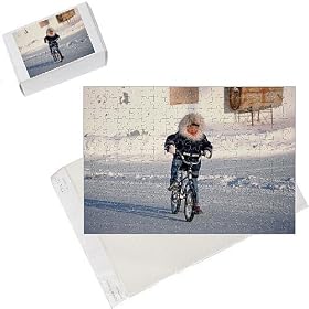 Photo Jigsaw Puzzle of Inuit boy cycling on his mountain bike on the main street in Igloolik from ArcticPhoto