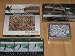 Collection of (4) Maritime Fishing Puzzles & Game: Hooked on Fishing 550 Pieces, Jean Guichard Tri-Panoramic of Kereon Lighthouse 750 Pieces, GAMEFISH of the USA 550 Pieces in Collectible Tin, Fly Fishin' Rod n' Reel Electronic Game. All for one shipping cost!
