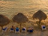 Guests Relax at Sunset Along the Water at the Caribe Blu Hotel, Cozumel, Mexico Photographic Poster Print by Michael S. Lewis, 12x16