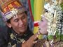 An Acehnese Bridegroom Cleans Face of His Bride During a Mass Wedding for Tsunami Victims Photographic Poster Print, 24x18