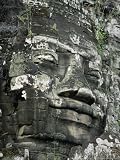 A Serene Likeness of Buddha Sculpted of Stone Peers from a Temple Wall National Geographic Collection Photographic Poster Print by Paul Chesley, 18x24