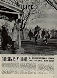 CHRISTMAS AT HOME: The James Ferdinand Irwin family of Neosho Rapids, Kansas celebrate Christmas early with their 20-year-old son Jack, Navy aviation ordnanceman second class, who had to return to duty by December 14. Pictured are family members Mr. Irwin, son Scotty, daughter Carolyn, daughter Betty, son Jim, daughter Myra Lee, son Jack, daughter Jeanne, Mrs. Irwin, sons-in-law Jeff Haney, Jeannes's husband, and Levern Love, Myra Lee's husband. Three oldest daughters give bottles to their three infant children. Jeanne, 22 with son Joe; Myra Lee, 23, with son John; and Betty 25, with daughter Julia Ann and 2 1/2-year-old daughter, Iris Beth. ..... 1945 LIFE Magazine Article, A5011A.