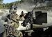 Wallmonkeys Peel and Stick Wall Decals - A Special Warfare Combatant-craft Crewman Reloading an M2 H