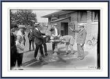 Photo (L): 4 men near drinking fountain in park