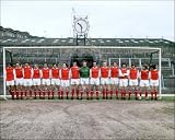 1971: Arsenal Football Club together in front of the goal at the clock end of their Highbury Stadium, London.