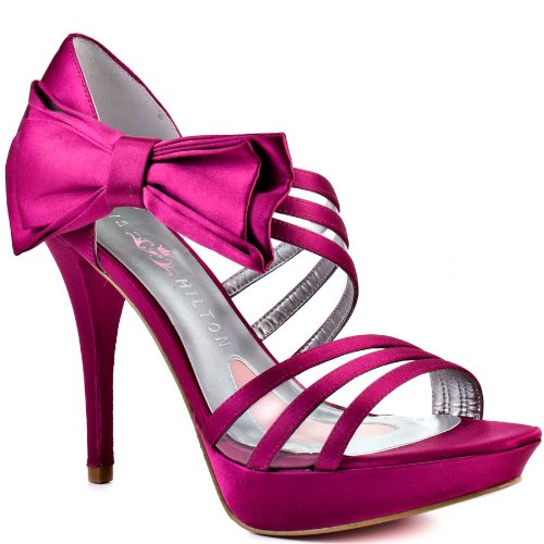 Sass it up in these domineering pumps from Paris Hilton.  Nila gives you a sleek fuchsia satin upper with clear panels in between the straps.  A bold and pretty bow at the side of this sandal brings you a girly look and perfects t...
