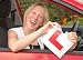 Happy Woman Just Passed Driving Test with Ripped L Plate - 24W x 17H - Peel and Stick Wall Decal by Wallmonkeys