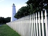 IMAGE OF The Lighthouse Stands Behind a Fence on Ocracoke Island Premium Photographic Poster Print by Stephen Alvarez, 18x24