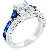 White Gold Rhodium Bonded with Radiant and Trillion Cut Sapphire Crystals and Round Cut Clear CZ Handset Along the Shank and Prong Set Princess Cut Center Stone in Silvertone
