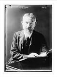 Newswire Photo (XL): G.B. Shaw at desk with book