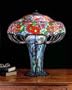 Meyda Tiffany 50352 Zinnia - Three Light Table Lamp, Mahogany Bronze Finish with Light Blue Flame Orange Pink Glass