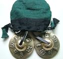 Tibetan Buddhist Lotus Hand Bells on leather cord; embossed with the Mantra of the Buddha of Compassion - 'Om Mani Padre Hum'; 62cms Diameter. Comes in a Drawstring Storage Pouch - Sold by Spiritual Gifts. Usually dispatched within 2 working days.