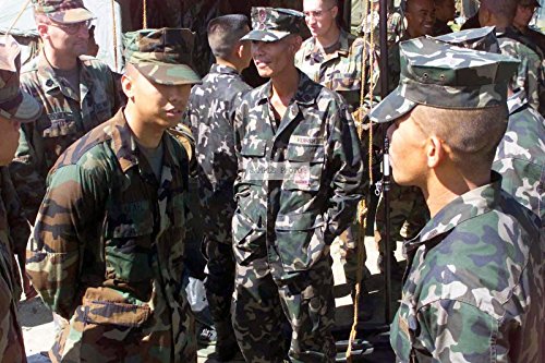 Photo US Marine Corps (USMC) Lance Corporal (LCPL) Dan Rafael (left) 1ST Battalion, 6th Marines discusses weapon similarities with Philippine Marine Corps Technical Sergeant (TSGT) Balita, during Exercise TALON VISIOIN 02 at Fort Magsaysay, Philippines. The exercise is designed to improve military relations and operability with the US Armed Forces and the Philippine Armed Forces, 11/13/2002