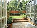 Jigsaw of view through patio door Past conservatory towards the lawn from Arcaid