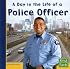 A Day in the Life of a Police Officer (First Facts: Community Helpers at Work)